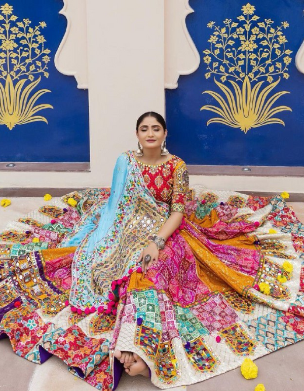 Multi-patterned lehenga and choli ensemble, complemented by a striking blue dupatta