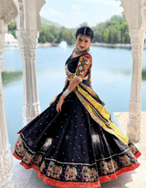 Black lehenga and matching choli, adorned with a matching dupatta