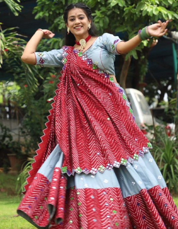 This stunning grey lehenga and choli ensemble, paired with a vibrant red dupatta.