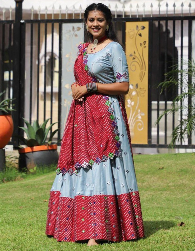 This stunning grey lehenga and choli ensemble, paired with a vibrant red dupatta.