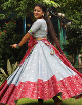 This stunning grey lehenga and choli ensemble, paired with a vibrant red dupatta.