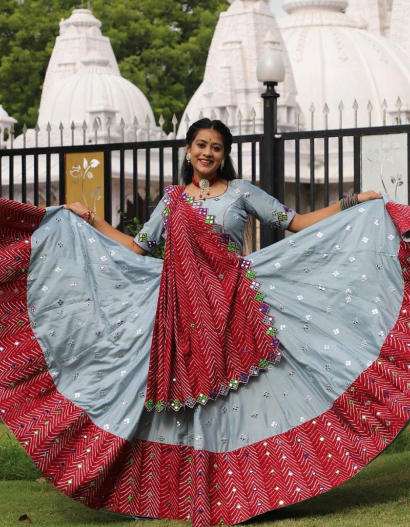 This stunning grey lehenga and choli ensemble, paired with a vibrant red dupatta.