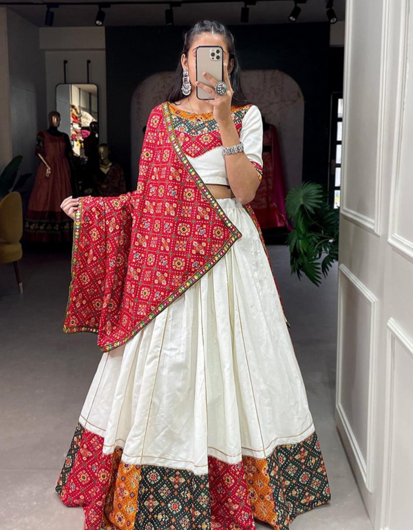 This white lehenga and choli ensemble, paired with a bold red dupatta