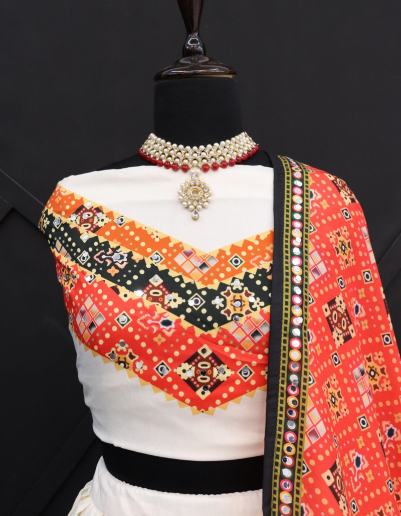 This white lehenga and choli ensemble, paired with a bold red dupatta