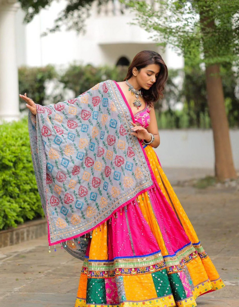 Pink and yellow lehenga, paired with a matching pink choli and a beautifully printed dupatta