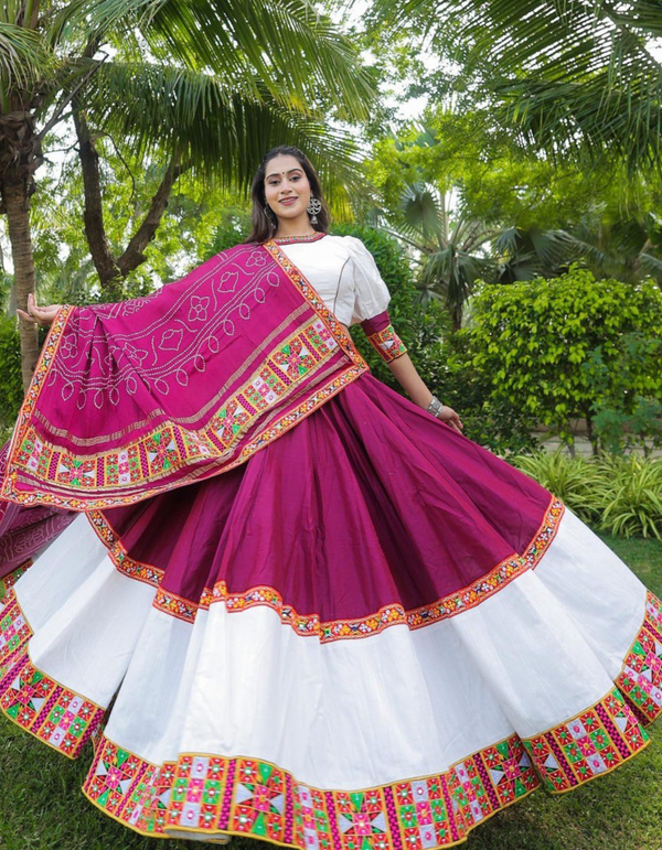 This stunning combination of a white lehenga and choli paired with a maroon dupatta