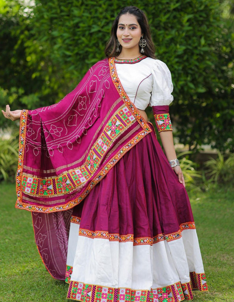 This stunning combination of a white lehenga and choli paired with a maroon dupatta