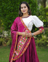 This stunning combination of a white lehenga and choli paired with a maroon dupatta