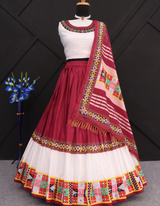 This stunning combination of a white lehenga and choli paired with a maroon dupatta