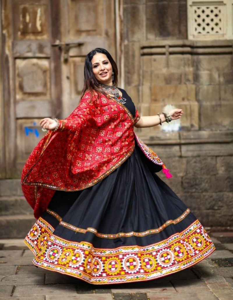 Black lehenga choli paired with a vibrant red dupatta, blending tradition