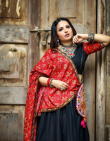 Black lehenga choli paired with a vibrant red dupatta, blending tradition