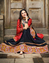 Black lehenga choli paired with a vibrant red dupatta, blending tradition