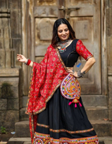 Black lehenga choli paired with a vibrant red dupatta, blending tradition