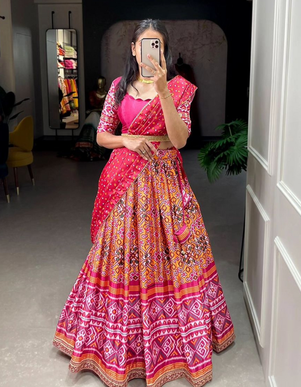 A light yellow lehenga, pink choli, and vibrant red dupatta