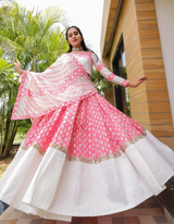 This white and pink lehenga choli ensemble with matching dupatta