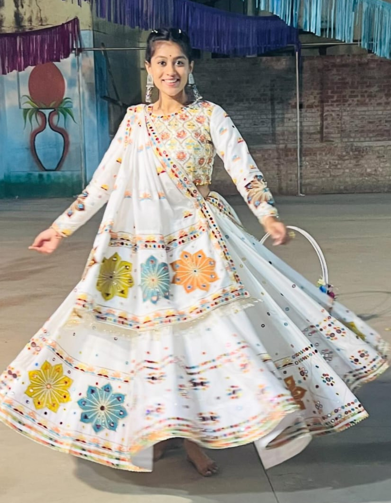 This pristine white lehenga choli ensemble, accompanied by a matching dupatta