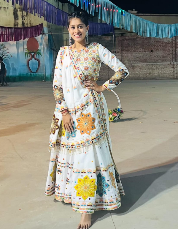 This pristine white lehenga choli ensemble, accompanied by a matching dupatta