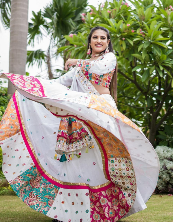 Stunning white and pink lehenga choli ensemble, complete with a flowing white dupatta.