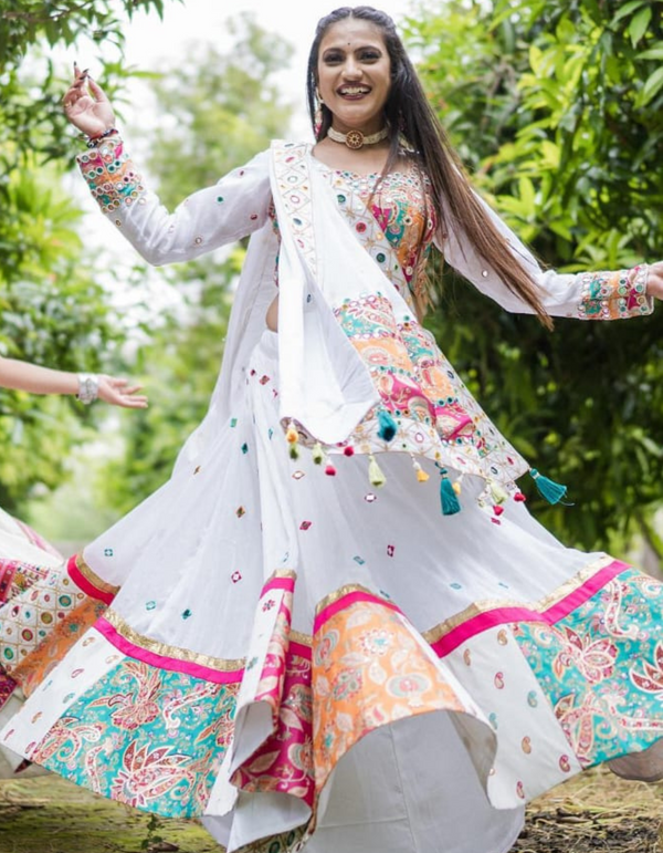 Stunning white and pink lehenga choli ensemble, complete with a flowing white dupatta.