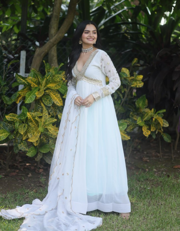 This white gown adorned with delicate embroidery exudes sophistication and grace