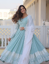 legance with this sky blue gown adorned with intricate embroidery, complemented