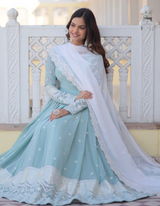 legance with this sky blue gown adorned with intricate embroidery, complemented