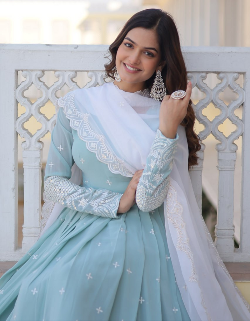 legance with this sky blue gown adorned with intricate embroidery, complemented